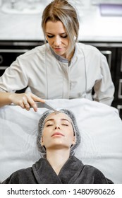 Female Cosmetologist Making Vacuum Hydro Peeling To A Woman At The Luxury Beauty Salon. Concept Of A Professional Facial Treatment