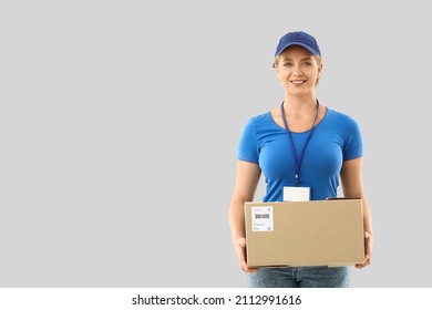 Female Courier With Parcel On Light Background