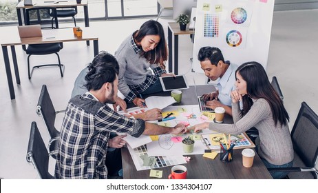 Female Creative Director Team Leader Brainstorm Branding Project With Designer Team At Meeting Table.discussion Idea In Creative Office