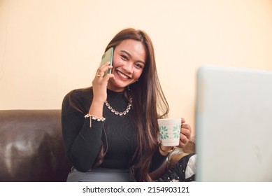 A female CSR agent enjoying her break time. Calling her friends and family to set a get together. Setting plan to relax. - Shutterstock ID 2154903121