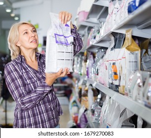 Female Customer Choose Pet Food In Zoo Store