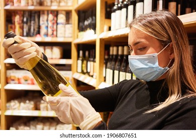 Female Customer With Face Mask And Gloves Buying Wine In The Supermarket