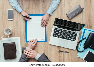 Female Customer Having A Meeting In The Office And Signing A Contract, Top View