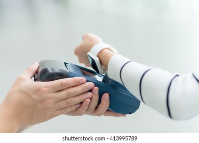 Female customer paying through smart watch - Powered by Shutterstock