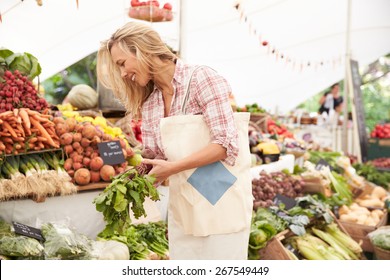 Female Customer Shopping At Farmers Market Stall