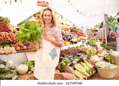 Female Customer Shopping At Farmers Market Stall