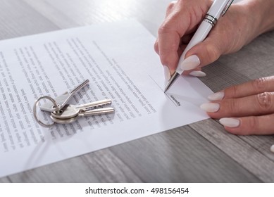 Female customer signing a real estate contract
