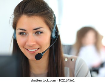 Female customer support operator with headset and smiling - Powered by Shutterstock