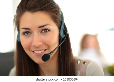 Female Customer Support Operator With Headset And Smiling