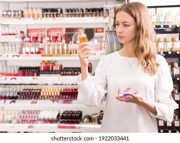 Female Customer Testing Perfume In Makeup Store