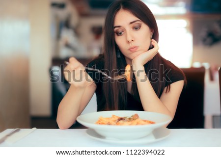 Female Customer Unhappy with the Dish Course in Restaurant. Depressed lonely woman suffering from appetite loss