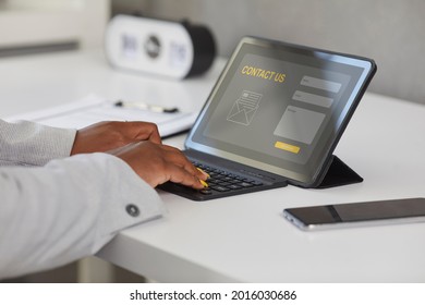 Female Customer Using Modern Tablet, Visiting Company Landing Page Website, Entering Personal Information, Leaving Message In Contact Us Form. Close Up Of Device Screen And Hands Typing On Keyboard