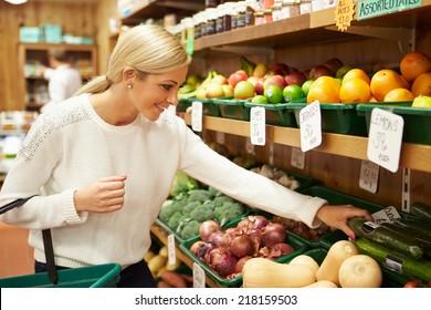 Female Customer At Vegetable Counter Of Farm Shop