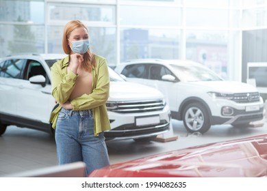 Female Customer Wearing Medical Face Mask, Buying New Car At Dealership