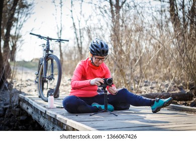 female cyclist blogger tunes steadicam - Powered by Shutterstock