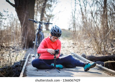 female cyclist blogger tunes steadicam - Powered by Shutterstock