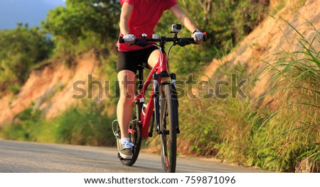 female cyclist cycling mountain bike on trail