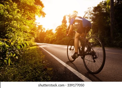 Female cyclist cycling am The path in the woods and mountains - Powered by Shutterstock