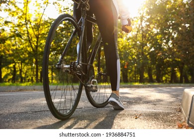 Female Cyclist Riding Bicycle Outdoors