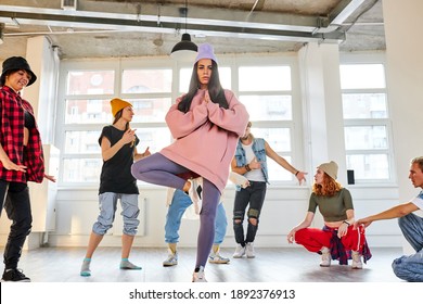 Female Dance Teacher Recording A New Dance Video In Studio With Pupils, Dancers Having A Rehearsal Together