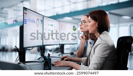 Female Data Analyst Analyzing KPIs on Office Computer Screen