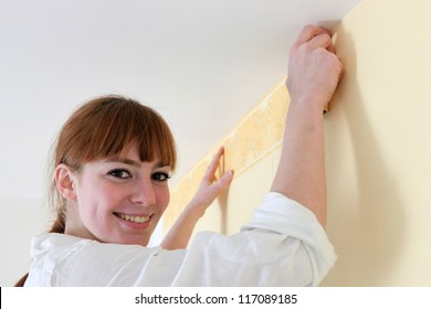 Female Decorator Hanging Wallpaper Border