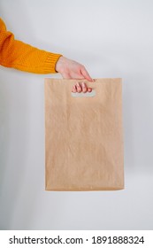 A Female Delivery Hand With Paper Shopping Bag