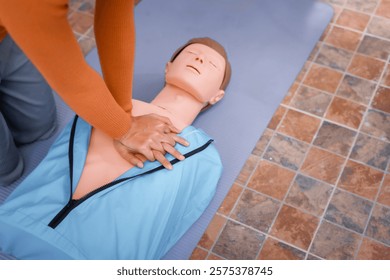 A female demonstrates CPR using dummy during life-saving training sessions,equipping participants with essential emergency skills ensure safety, provide critical care,respond effectively emergencies