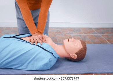 A female demonstrates CPR using dummy during life-saving training sessions,equipping participants with essential emergency skills ensure safety, provide critical care,respond effectively emergencies