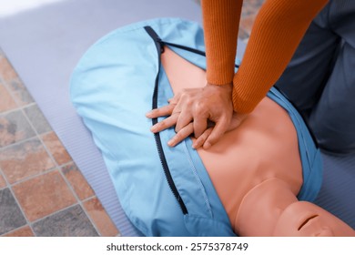 A female demonstrates CPR using dummy during life-saving training sessions,equipping participants with essential emergency skills ensure safety, provide critical care,respond effectively emergencies
