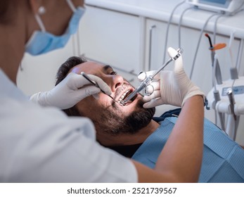 Female dentist applying anesthesia to a male patient on a dental clinic - Powered by Shutterstock