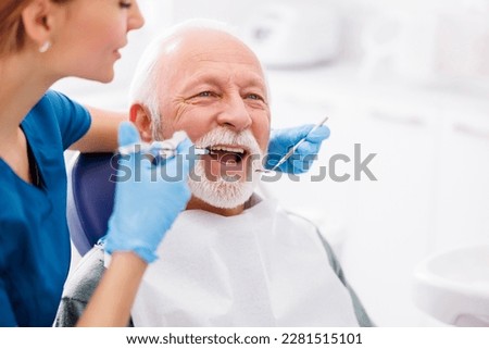 Female dentist applying local anesthetic to patient for numbing the pain before procedure Сток-фото © 