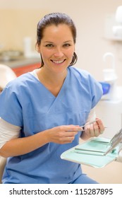 Female dentist with dental equipment at surgery smiling friendly staff