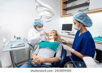 Female dentist examine tooth to Caucasian girl at dental health clinic. Attractive woman patient lying on dental chair get dental treatment from doctor during procedure appointment service in hospital - Powered by Shutterstock