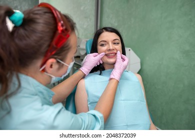 Female Dentist Hands Examines The Patient's Mouth, Dental Clinic