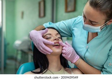 Female Dentist Hands Examines The Patient's Mouth, Dental Clinic