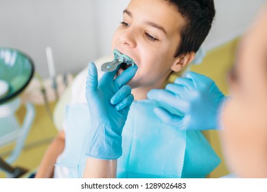 Female Dentist Makes Teeth Impression