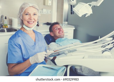 Female Dentist With Male Patient In Modern Dentistry
