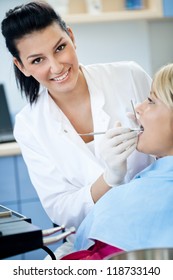 Female Dentist With Patient At The Clinic