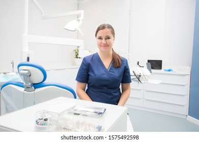 Female Dentist Sitting In A Treatment Room