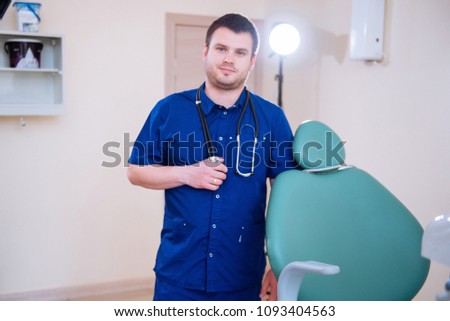 Female dentist standing with his hands crossed and looking at camera