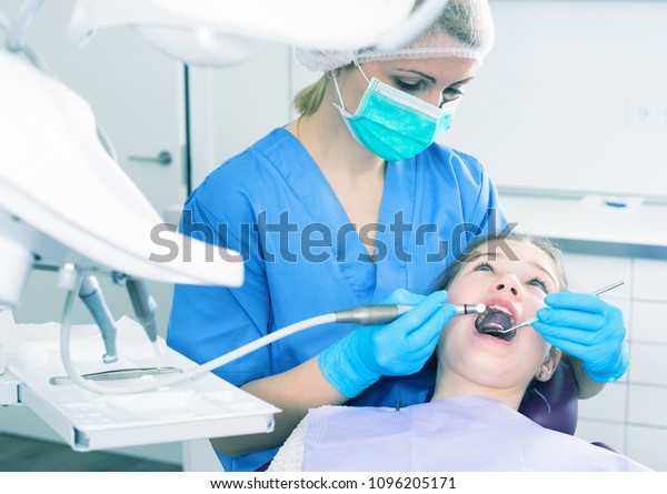 Female Dentist Treating Teen Girl Patient Stock Photo 1096205171 ...