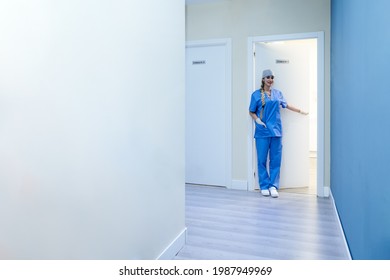 Female Dentist Waiting For A Patient At The Office Door