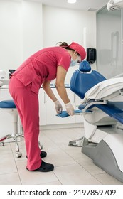 Female Dentist Working In Modern Dental Clinic And Wearing Face Mask. She Is Also Wearing Dental Safety Glasses.