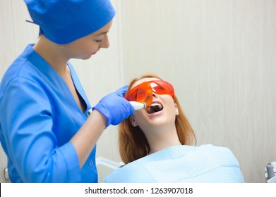 female dentists treating patient - Powered by Shutterstock