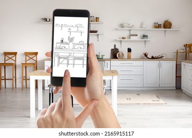 Female Designer Holding Mobile Phone With Drawing Of New Kitchen Interior