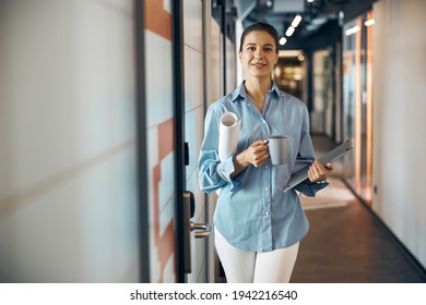 Female designer with a mug coffee looking ahead - Powered by Shutterstock