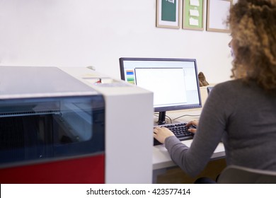 Female Designer Operating CAD System For Laser Cutter