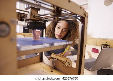 Female Designer Working With 3D Printer In Design Studio