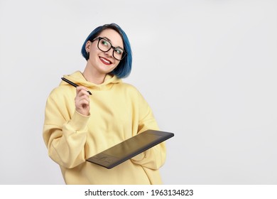 A female designer in yellow hoody holding graphic tablet. The white background - Shutterstock ID 1963134823